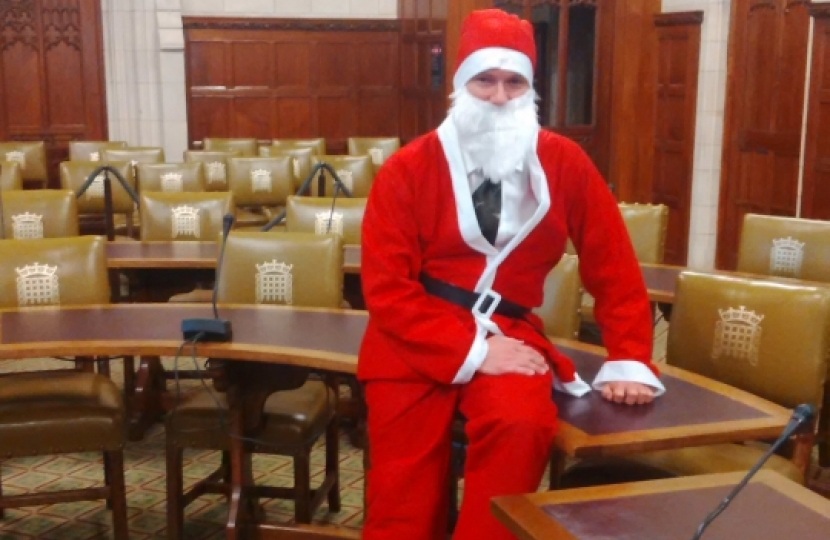 Henry Smith MP taking part in Wear a Santa Suit Day for Chestnut Tree House